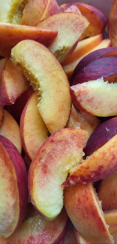 Vibrant slices of fresh peaches piled in a bowl.