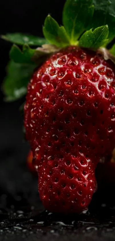 A fresh strawberry with green leaves on a dark textured surface, ideal for mobile wallpaper.