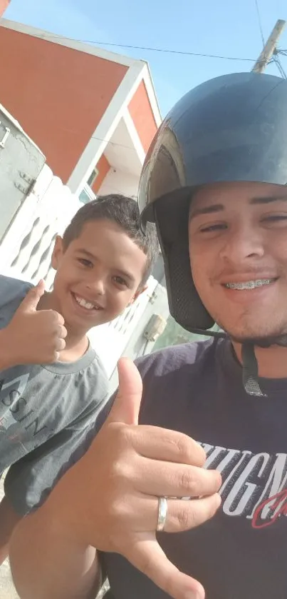 Two smiling friends taking a selfie outside on a sunny day.