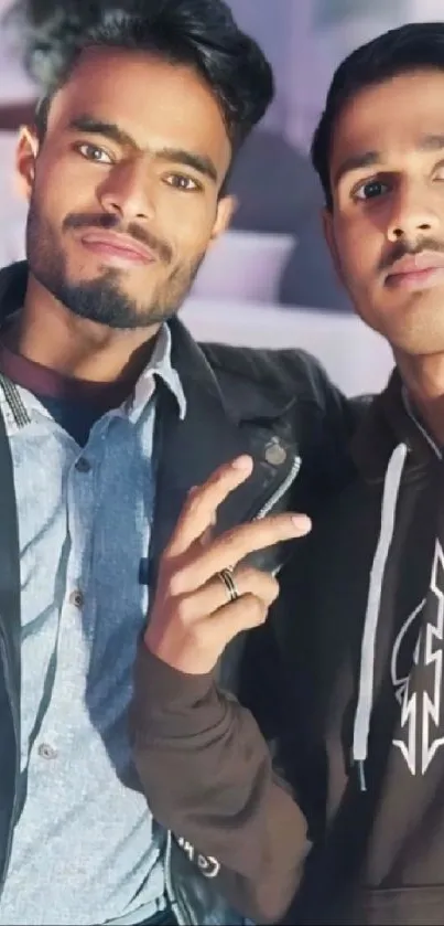 Two stylish friends posing together in trendy outfits.