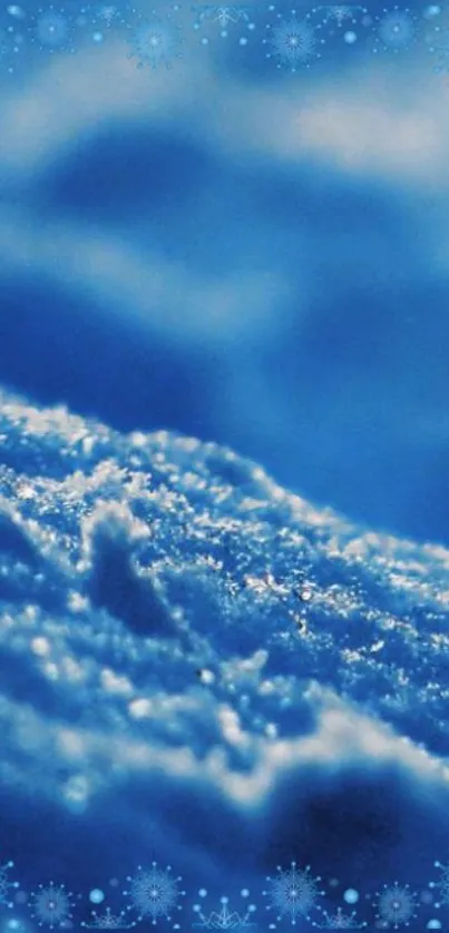 Frosty blue snow close-up wallpaper with shimmering snowflakes.