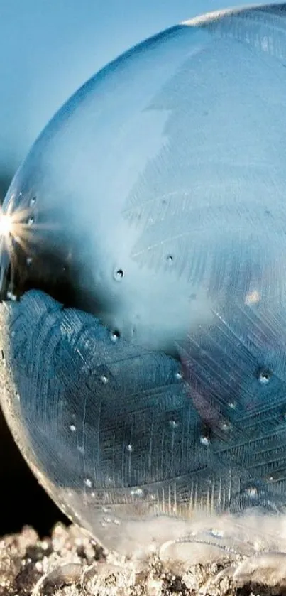 Close-up of a frosted bubble on icy surface with sky blue background.