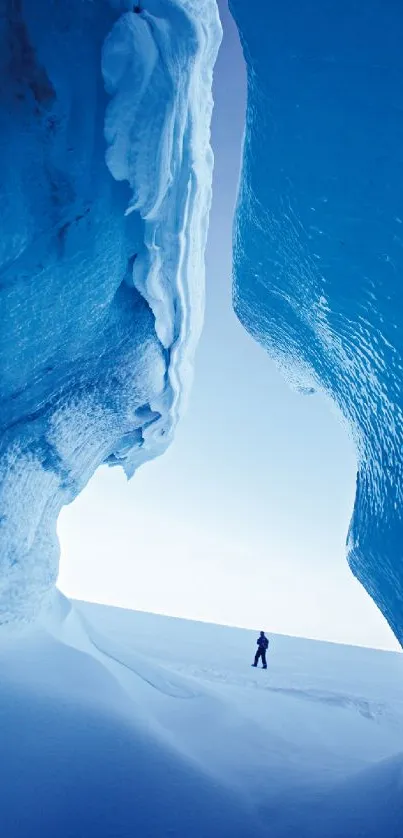 Scenic view inside a frozen blue ice cave with winter landscape.