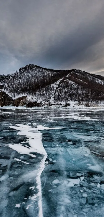 Majestic frozen mountain lake with icy surface and snow-covered peaks.