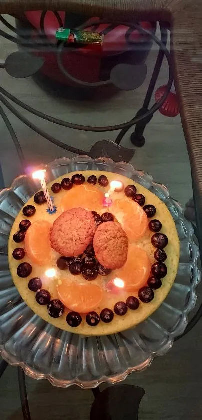 A colorful dessert with oranges, cookies, and berries on a glass plate.