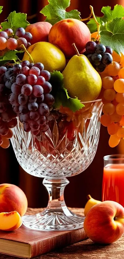 A colorful arrangement of fruits in a crystal glass with a juice glass.