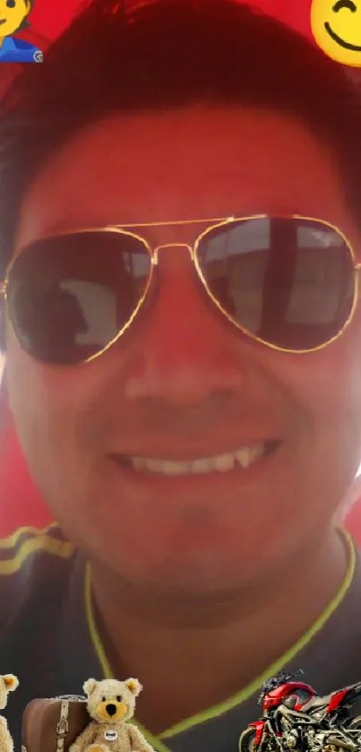 Smiling person in sunglasses with playful emojis on red background.