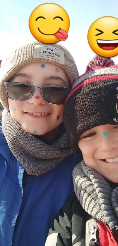 Friends with fun emojis in winter attire, smiling outdoors.