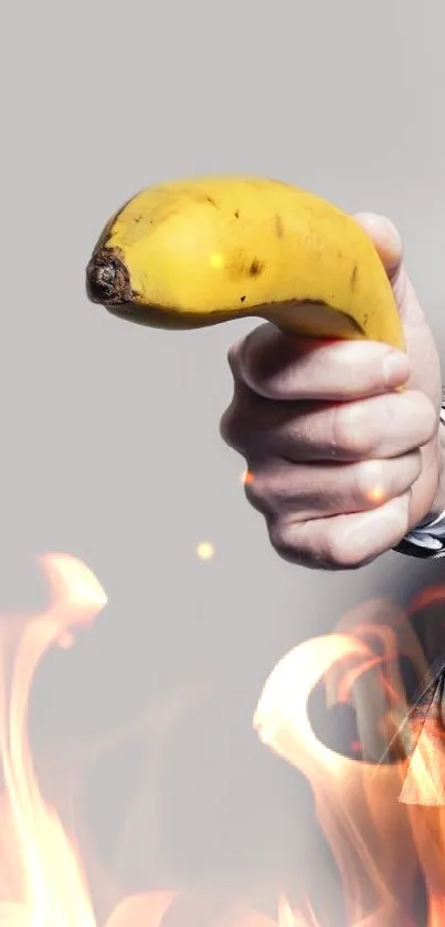 Man in suit humorously pointing banana on gray background.