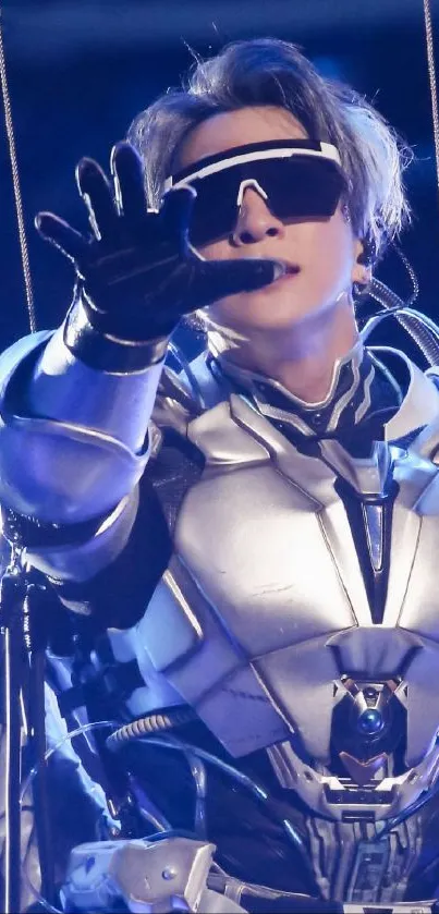 A person wearing futuristic armor and sunglasses on stage.