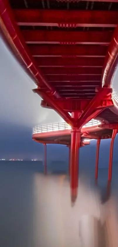 Futuristic red bridge over calm waters at night.