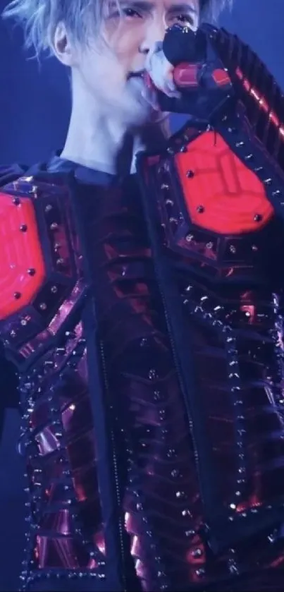 Futuristic performer in red and black armor on stage.