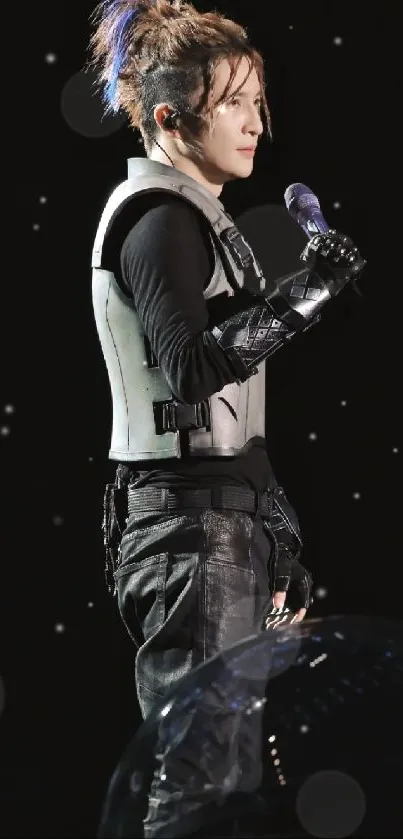 Futuristic performer on stage in dynamic black attire.