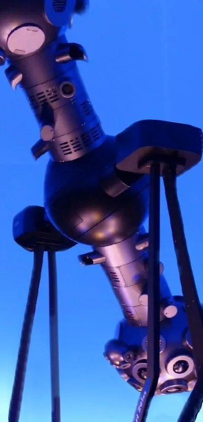 Futuristic gadget with a blue sci-fi glow in a tech-themed wallpaper.