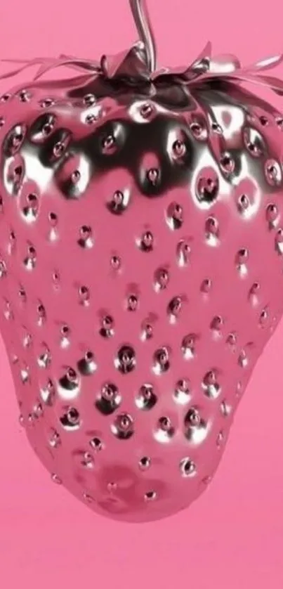 Metallic silver strawberry on pink background.