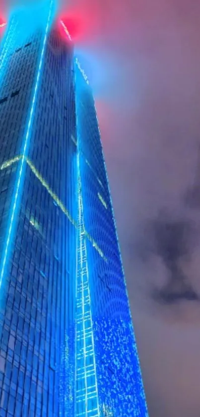 Futuristic skyscraper with vibrant neon lights at night.