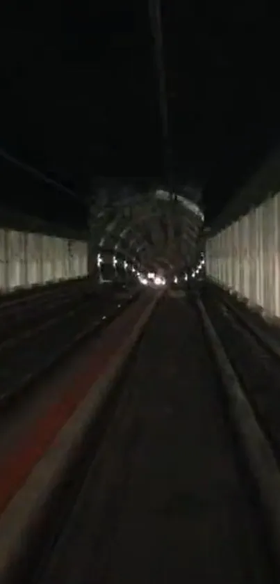 Futuristic tunnel with railway tracks and dark surroundings.