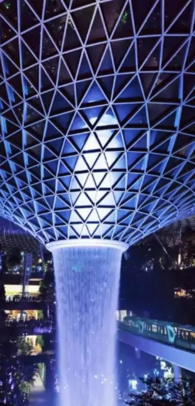 Futuristic geometric dome with illuminated waterfall.