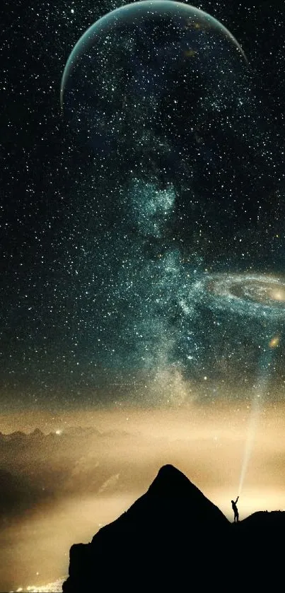 Man standing on mountain under starry galaxy and planet sky.