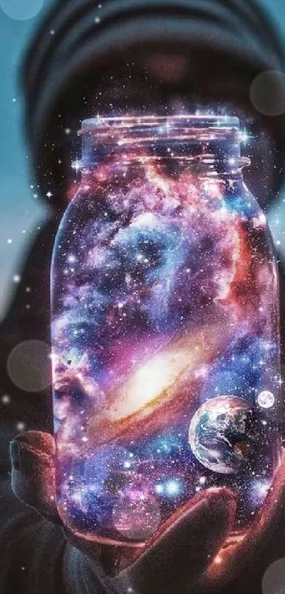 A person holding a jar with a vivid galaxy scene inside, set against a dark background.