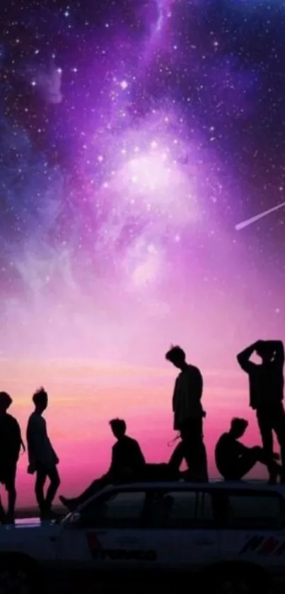 Silhouetted figures on a car beneath a vibrant, purple galaxy night sky.