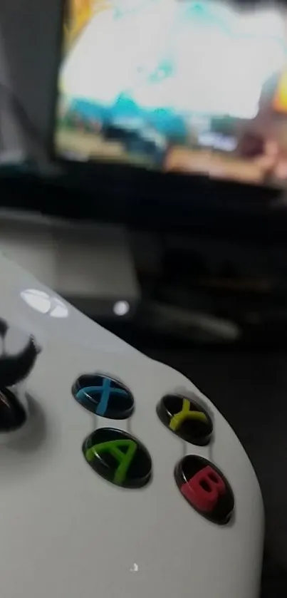 Close-up of a game controller with focus on colorful buttons.