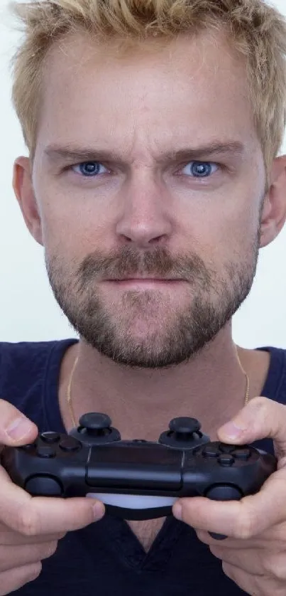 Intense gamer holding a controller with focused expression in a blue-toned wallpaper.