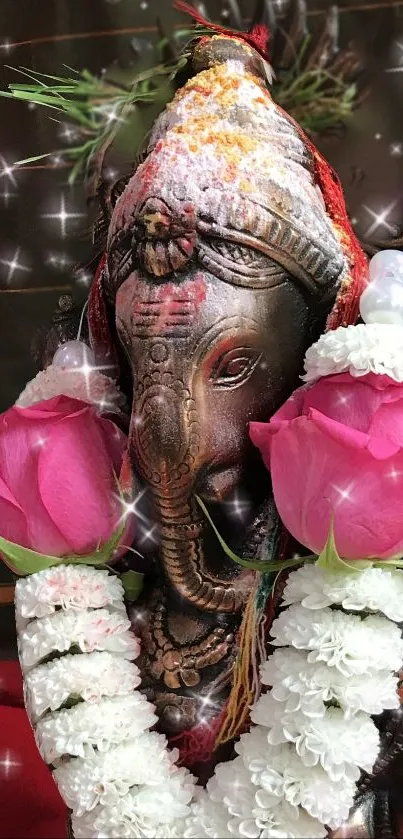 Ganesh idol with pink flowers and garland in a spiritual setting.