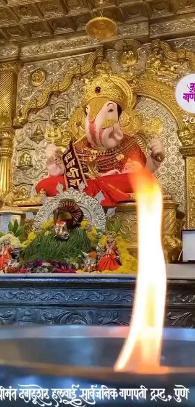 Ganesh statue in a traditional temple with a decorative background.