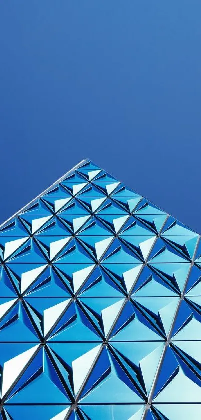 Geometric blue building against a clear sky