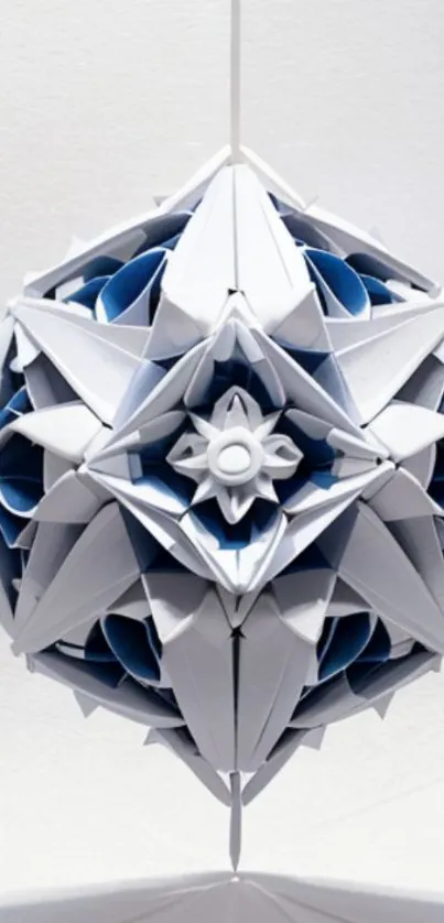 Intricate geometric origami ball hanging against a white background.