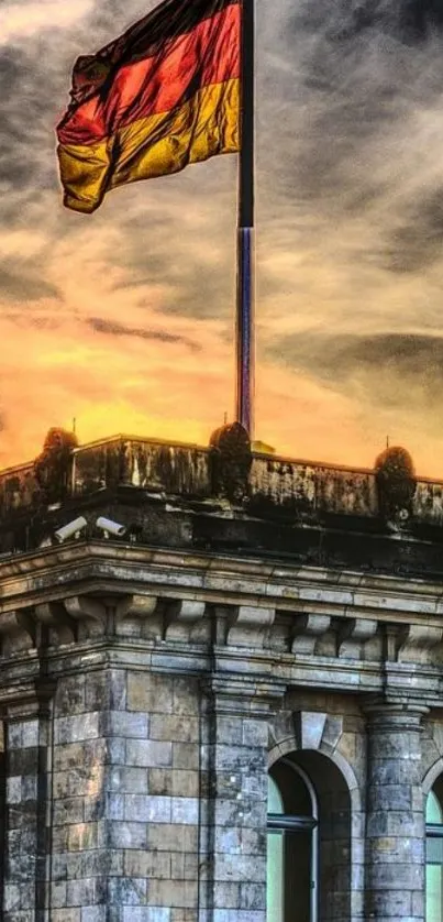 German flag waves over historic building at sunset.