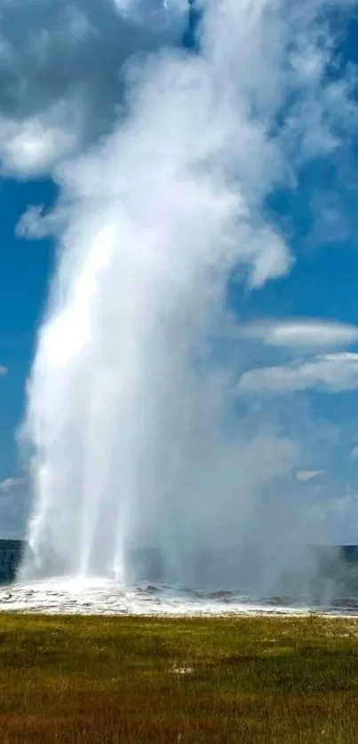 Geyser erupting under a vibrant blue sky.