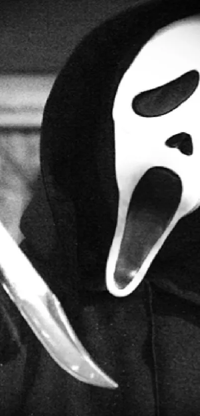 Ghostly mask with knife in a horror-themed wallpaper.