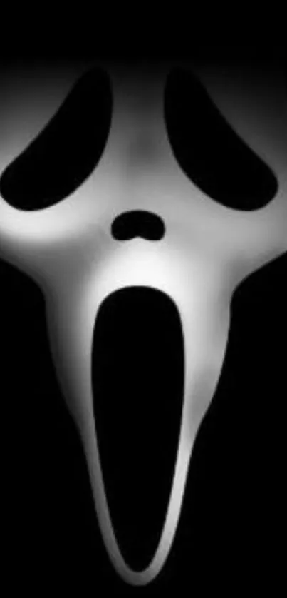 Ghostly mask on black background wallpaper.