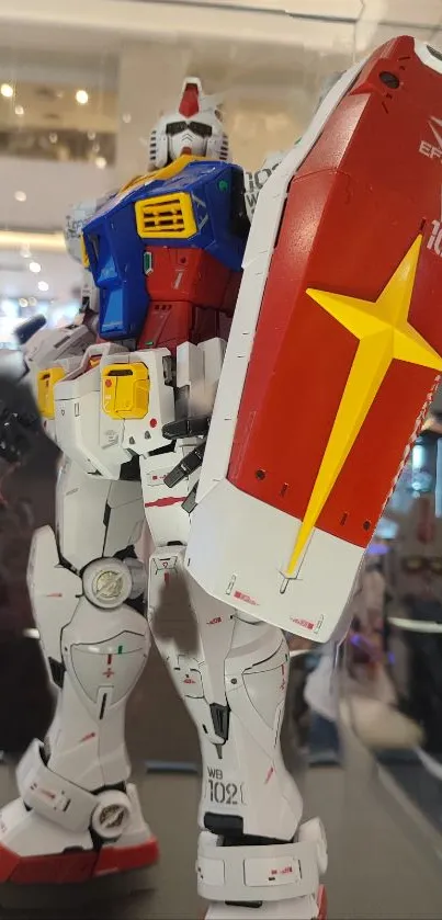 Vibrant giant robot model with shield in a display case.