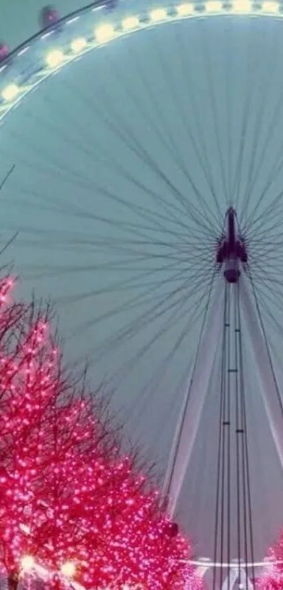 Giant Ferris wheel with vibrant pink trees at night.