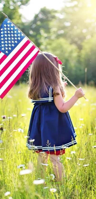 Girl in field holding American flag.