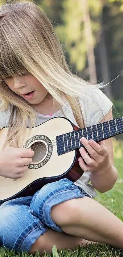 Young girl playing guitar on green grass in sunny outdoors.