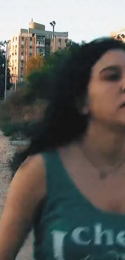 Woman running in an urban setting with buildings in the background.