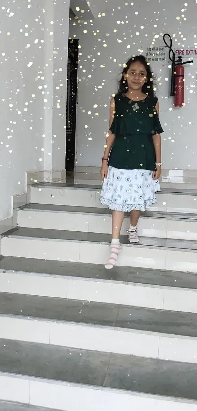 Girl in green top descending stairs with sparkles.