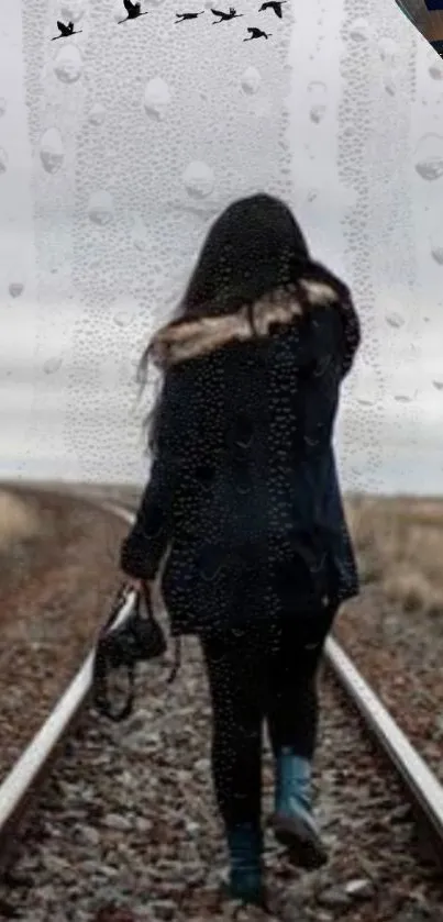 A girl in a coat walks on railway tracks in the rain.