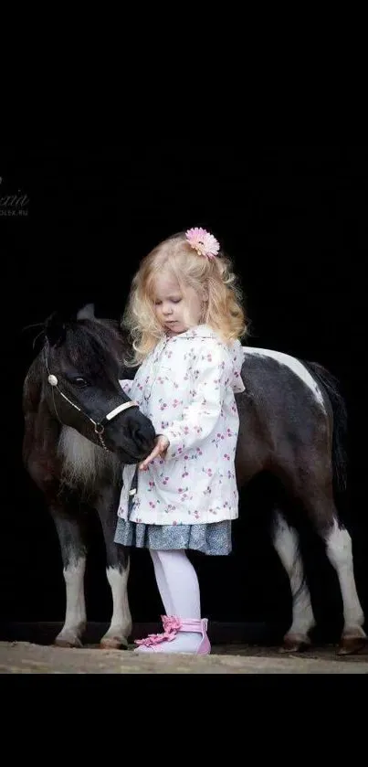 Little girl with pony against black background.