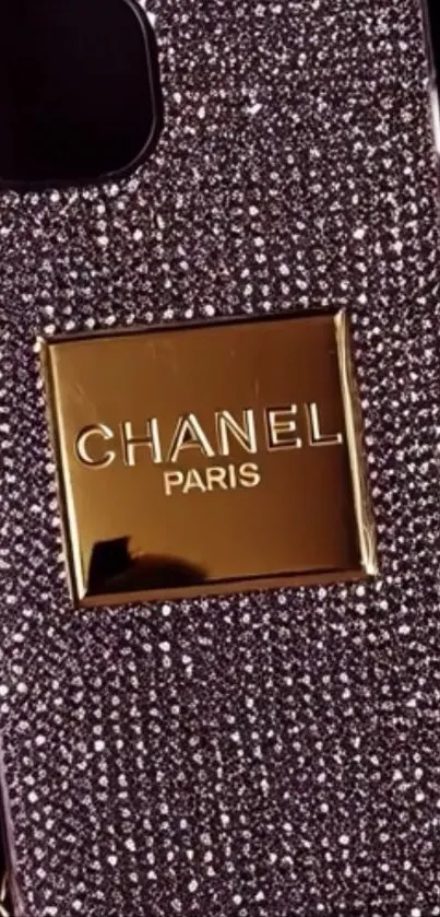 Luxurious phone case with diamond and gold design.