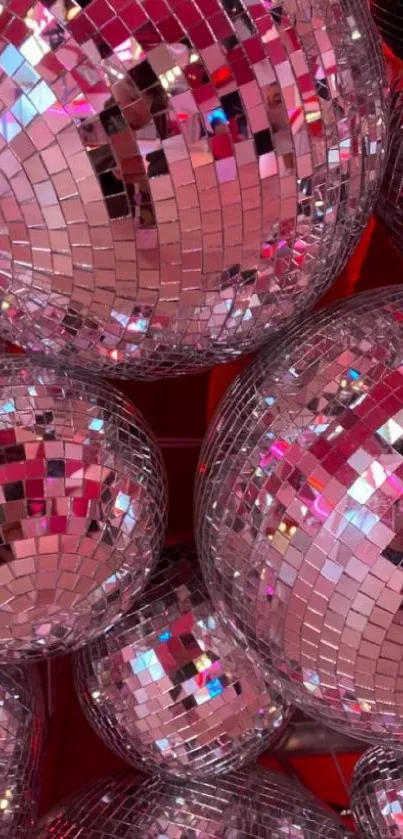 Multiple pink disco balls with dazzling reflections.