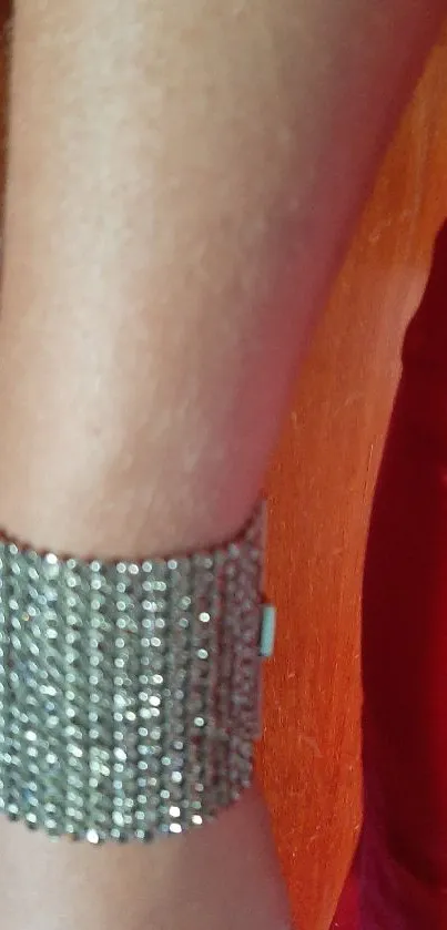 Arm in red dress with sparkling bracelet.