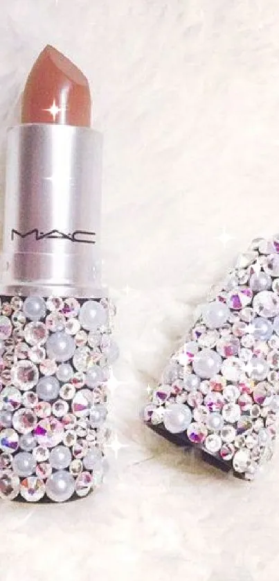 Rhinestone-studded lipstick on a fluffy white surface.