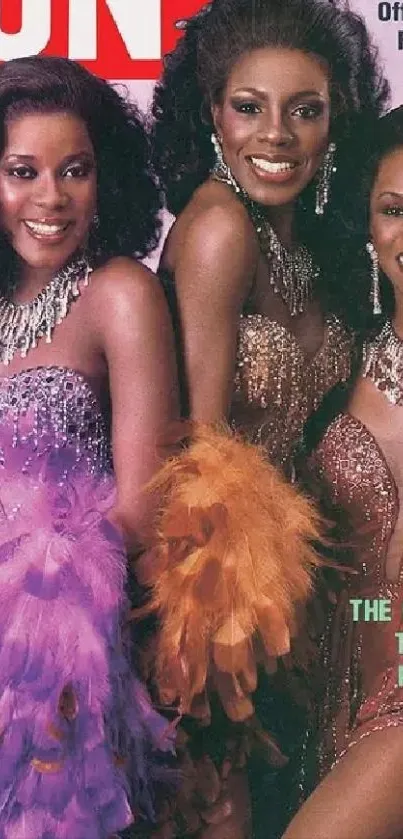 Three women in sparkling gowns with vibrant feathers pose elegantly.