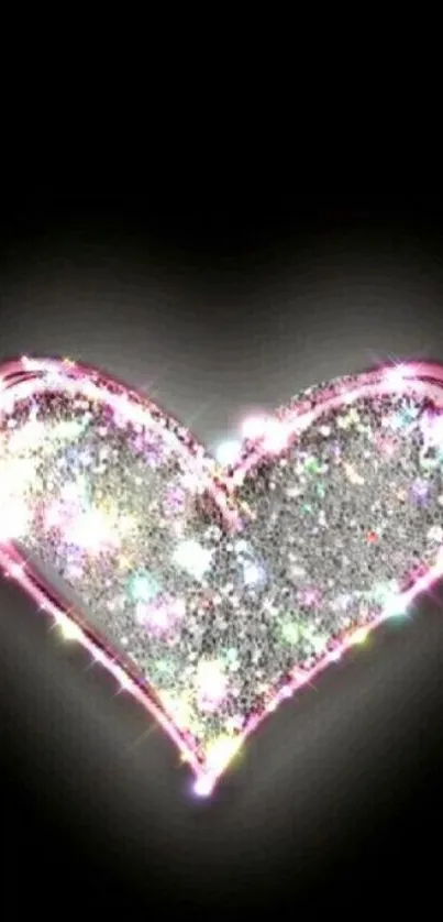 Glittery heart with pink accents on black background.