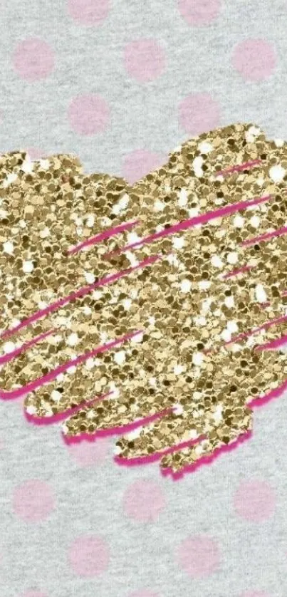 Gold glitter heart on pastel pink polka dot background.